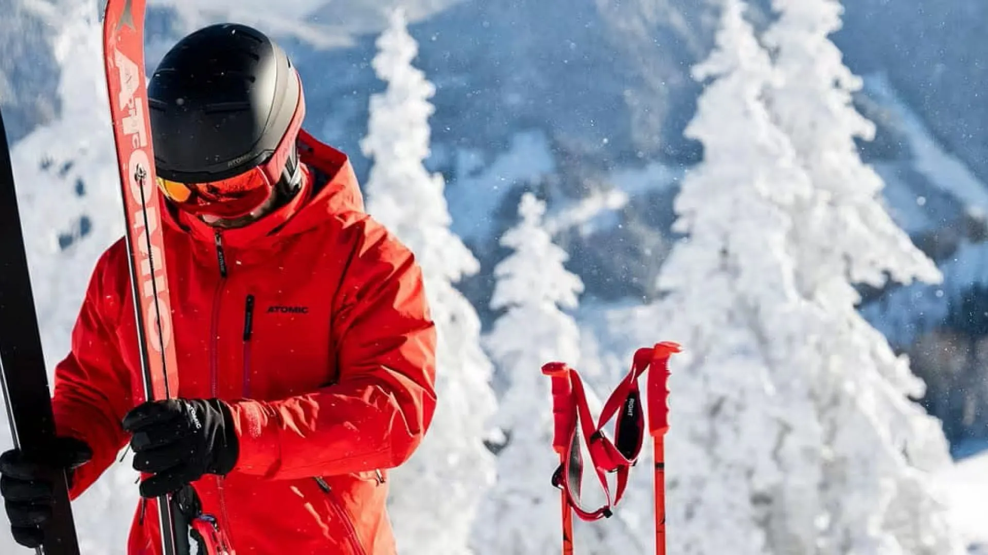Skier in red jacket on snowy mountain