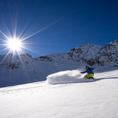 Skier in Pitztal, bright sun, snow-covered mountains